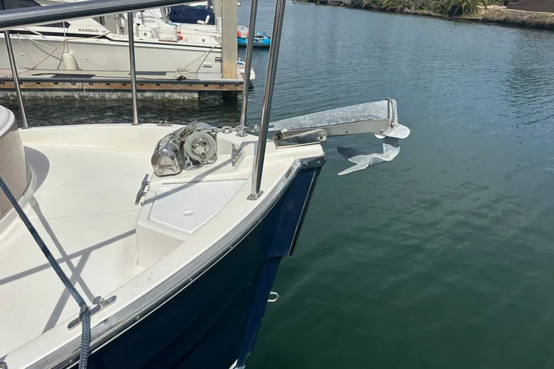 Slide: The Image of 2009 Ranger Tugs R-25 boat bow with anchor, docked on calm water. - 9