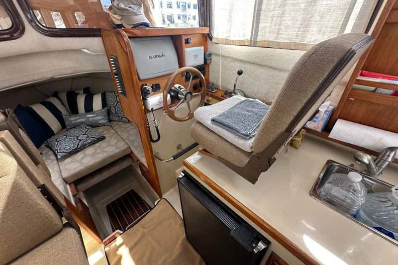 Slide: The Image of Interior of 2009 Ranger Tugs R-25 boat with helm, seating, and navigation equipment. - 23