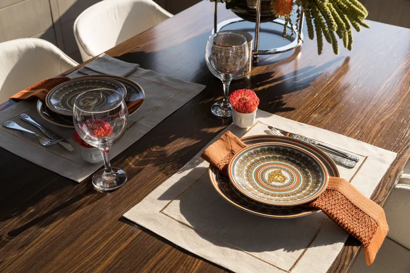 Slide: The Image of Elegant dining setup on Sirena 78 yacht, featuring ornate plates and wine glasses, 2027 model. - 29
