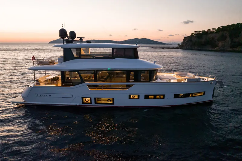 Slide: The Image of Luxury Sirena 78 yacht cruising at sunset, 2027 model, elegant design and spacious deck. - 1
