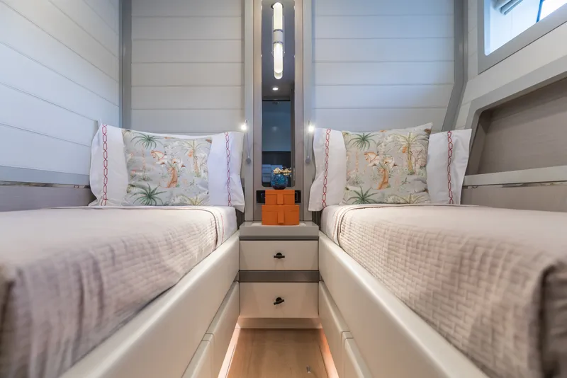 Slide: The Image of Luxurious twin cabin interior on 2027 Sirena 78 yacht, featuring elegant bedding and decor. - 40