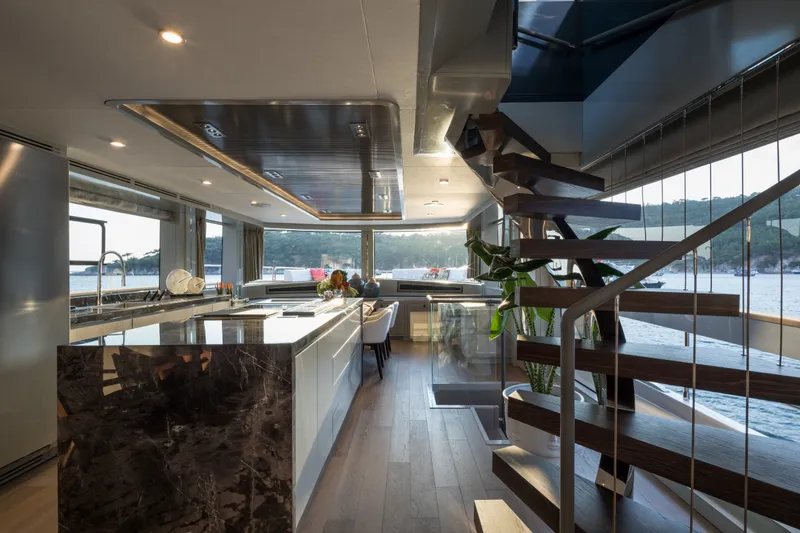 Slide: The Image of Luxurious interior of 2027 Sirena 78 yacht with modern kitchen and elegant staircase. - 25