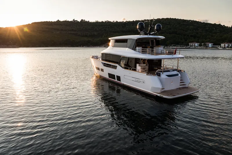 Slide: The Image of Luxurious Sirena 78 yacht on serene water at sunset, 2027 model. - 6