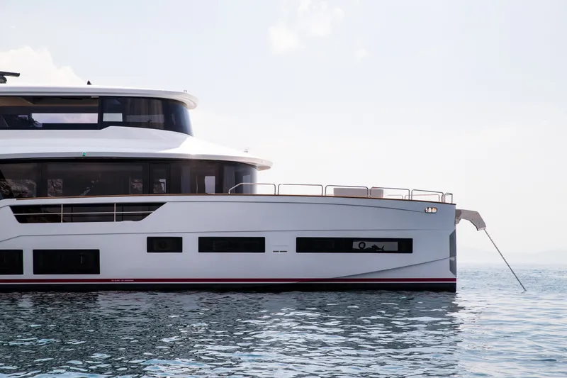 Slide: The Image of Luxury Sirena 78 yacht from 2027 on calm waters, showcasing sleek design. - 3