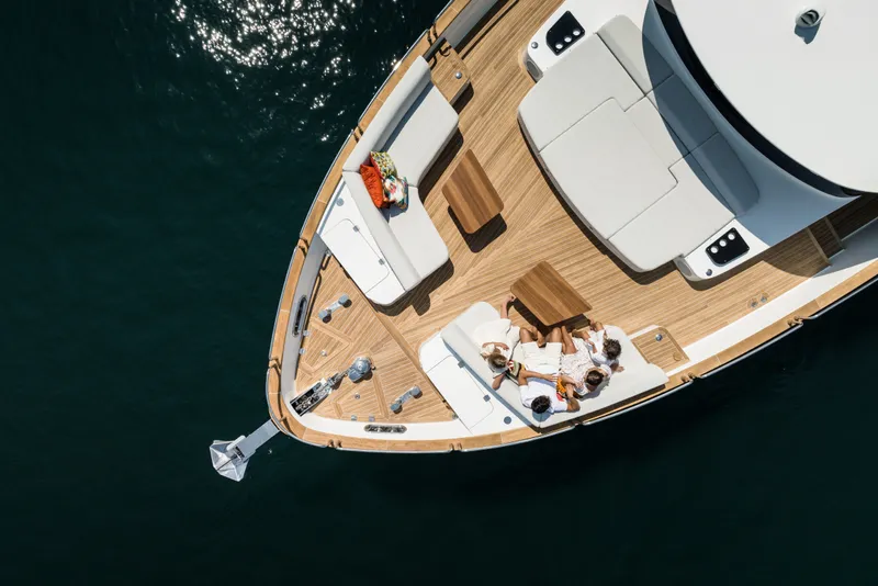 Slide: The Image of Aerial view of Sirena 78 yacht deck, 2027 model, with people relaxing on sunbeds. - 11