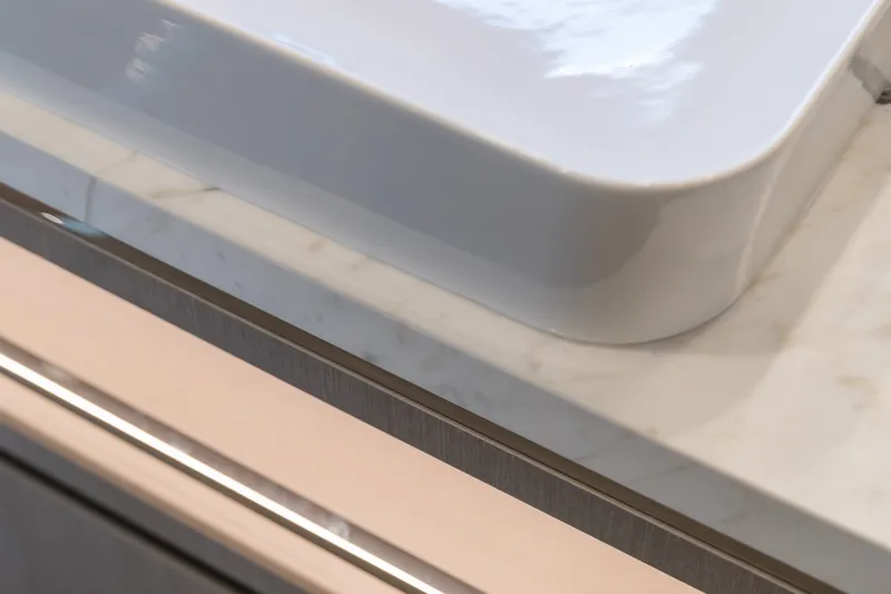 Slide: The Image of Close-up of a modern white sink on a marble countertop, Sirena 78, 2027 model. - 37