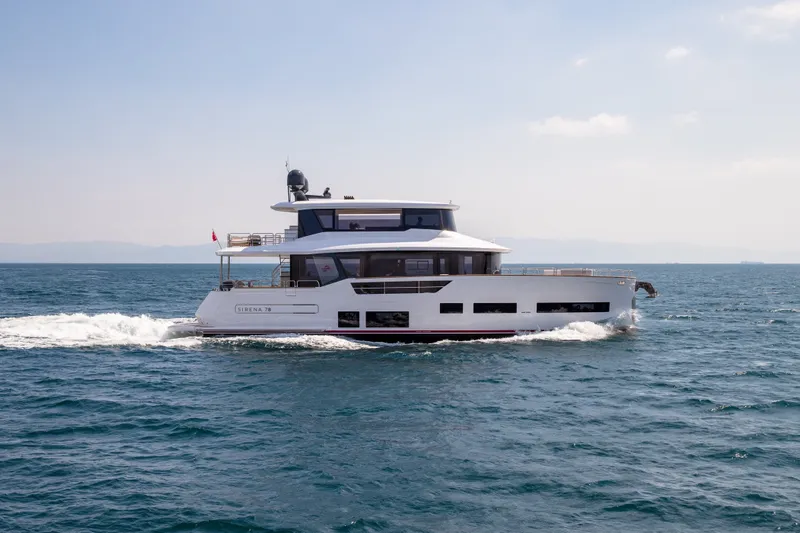 The Image of The 2027 Sirena 78 cruises on calm waters, featuring a modern design and spacious deck. - 0