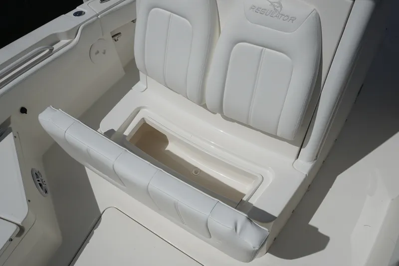 Slide: The Image of 2021 Regulator 24XO boat seat with storage compartment open. - 26