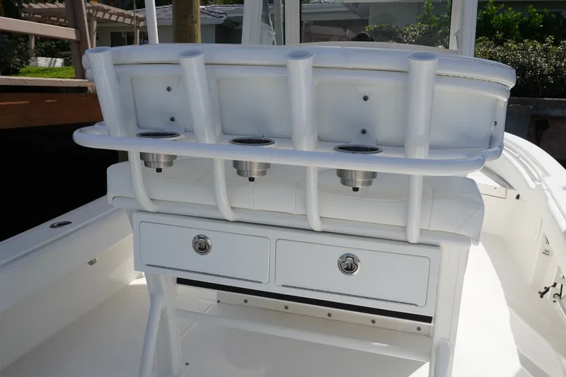 Slide: The Image of 2021 Regulator 24XO boat interior with rod holders and storage drawers. - 13