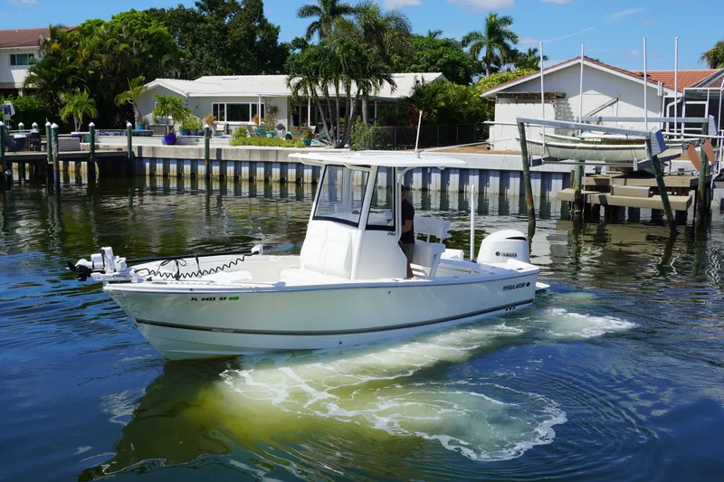 Slide: The Image of 2021 Regulator 24XO boat cruising in a scenic waterfront setting. - 37