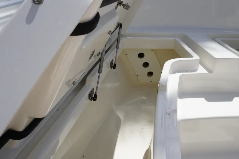 Slide: The Image of 2021 Regulator 24XO boat storage compartment with open hatch and hydraulic supports. - 23