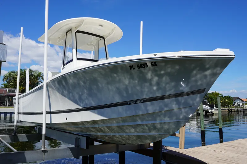 Slide: The Image of 2021 Regulator 24XO boat docked on a sunny day, showcasing sleek design. - 34