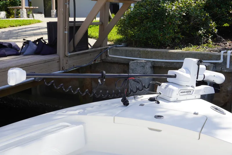 Slide: The Image of 2021 Regulator 24XO boat with Minn Kota trolling motor at dockside. - 22