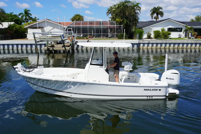 The Image of 2021 Regulator 24XO boat on calm water near residential dock. - 0