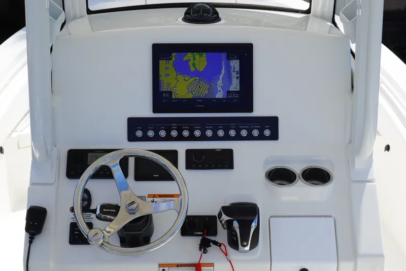 Slide: The Image of 2021 Regulator 24XO boat dashboard with navigation screen and controls. - 15