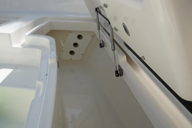 Slide: The Image of Open storage compartment on a 2021 Regulator 24XO boat, showcasing interior details. - 24