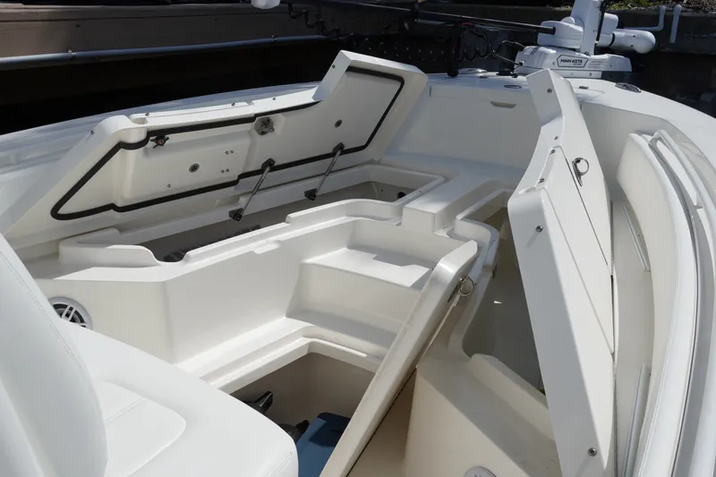 Slide: The Image of 2021 Regulator 24XO boat interior with open storage compartments and seating. - 27