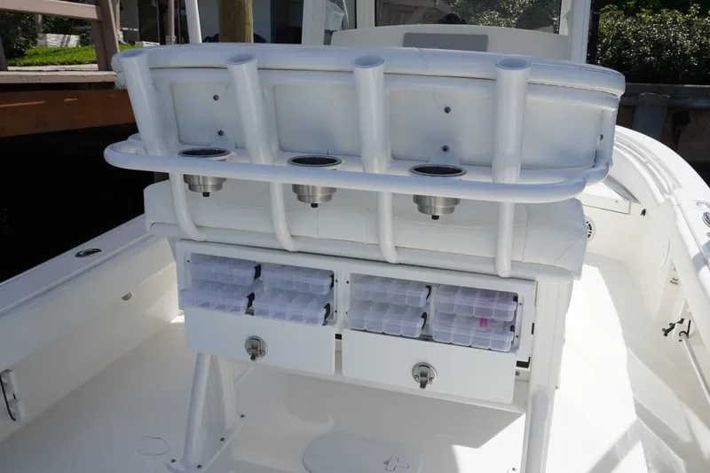 Slide: The Image of 2021 Regulator 24XO boat interior with rod holders and storage compartments. - 14