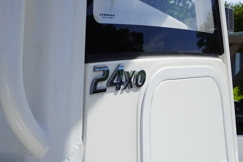 Slide: The Image of 2021 Regulator 24XO boat emblem on white exterior. - 18