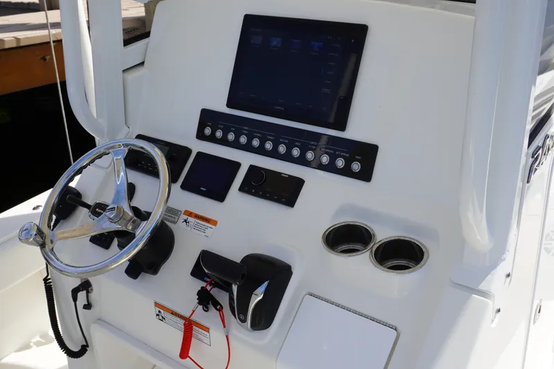 Slide: The Image of 2021 Regulator 24XO boat console with steering wheel, controls, and electronic displays. - 16