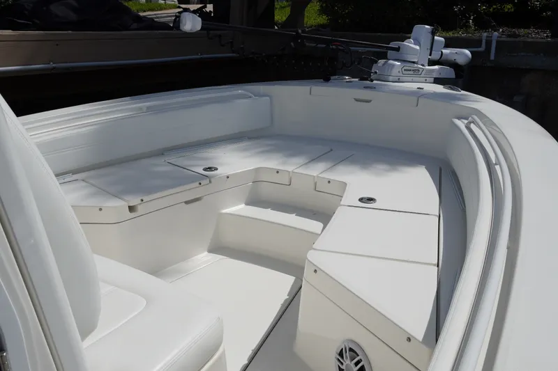Slide: The Image of 2021 Regulator 24XO boat interior with white seating and storage compartments. - 28