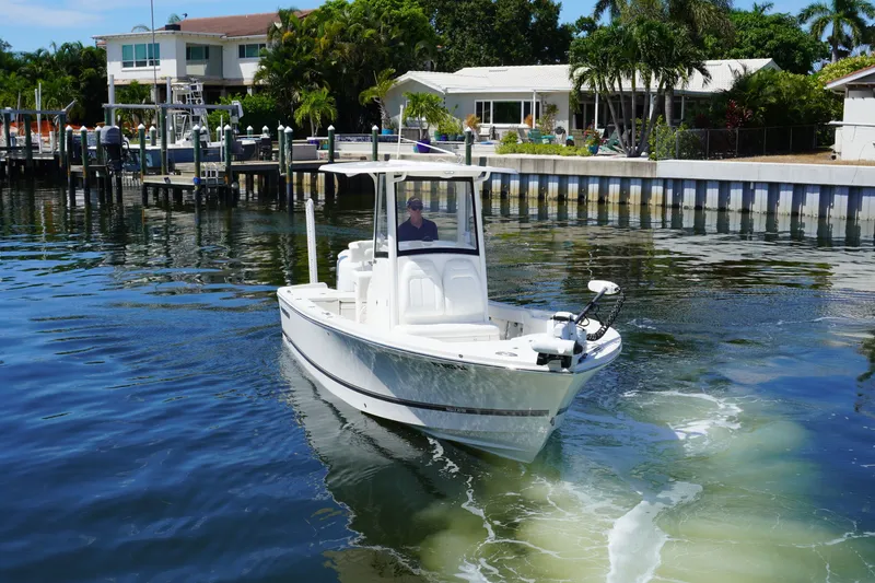 Slide: The Image of 2021 Regulator 24XO boat cruising near waterfront homes. - 39