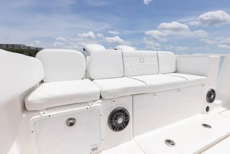 Slide: The Image of Manufacturer Provided Image: 2025 Sea Fox 268 Commander boat with white cushioned seating under a clear blue sky. - 15