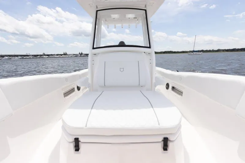 Slide: The Image of Manufacturer Provided Image: 2025 Sea Fox 268 Commander boat interior with white seating, on calm water. - 14