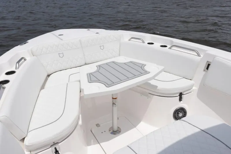 Slide: The Image of Manufacturer Provided Image: 2025 Sea Fox 268 Commander boat with white seating and table on calm water. - 16