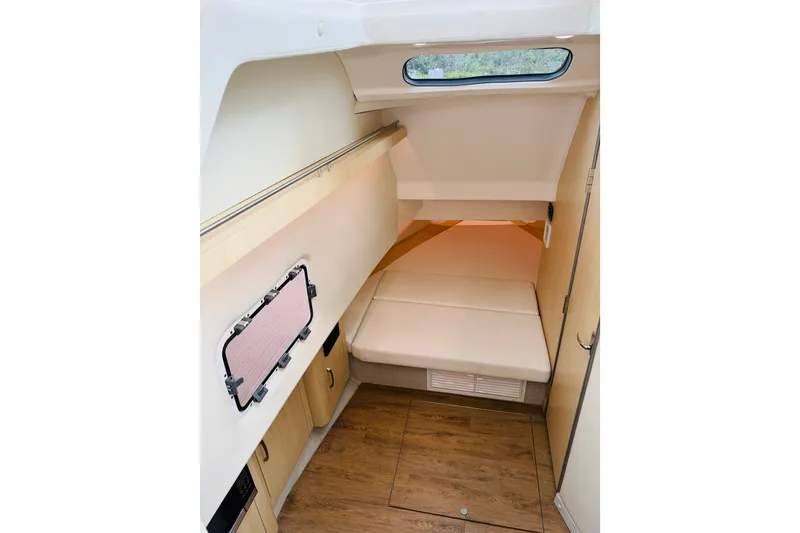 Slide: The Image of 2024 Regal 33 SAV cabin interior with bed, window, and wooden flooring. - 21