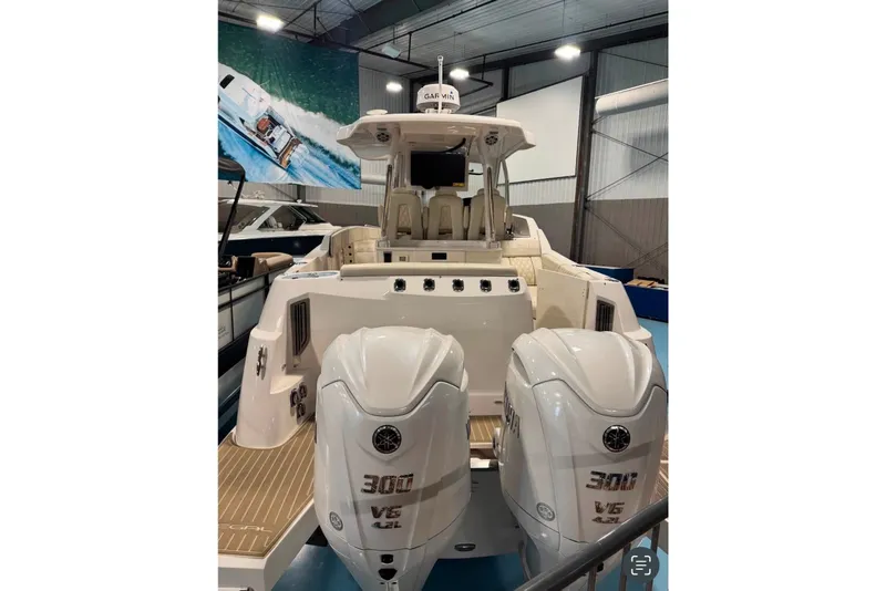 Slide: The Image of 2024 Regal 33 SAV boat with dual Yamaha 300 V6 engines in a showroom. - 3