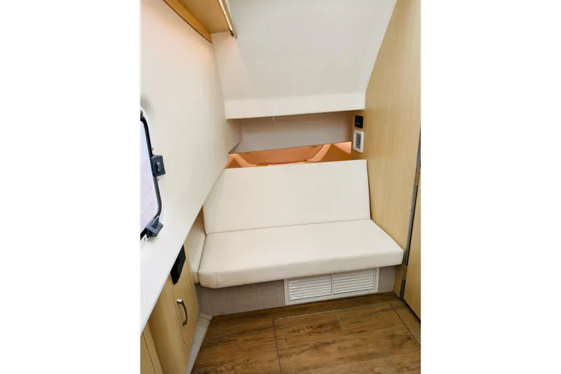 Slide: The Image of 2024 Regal 33 SAV interior cabin with wooden flooring and cushioned seating. - 20