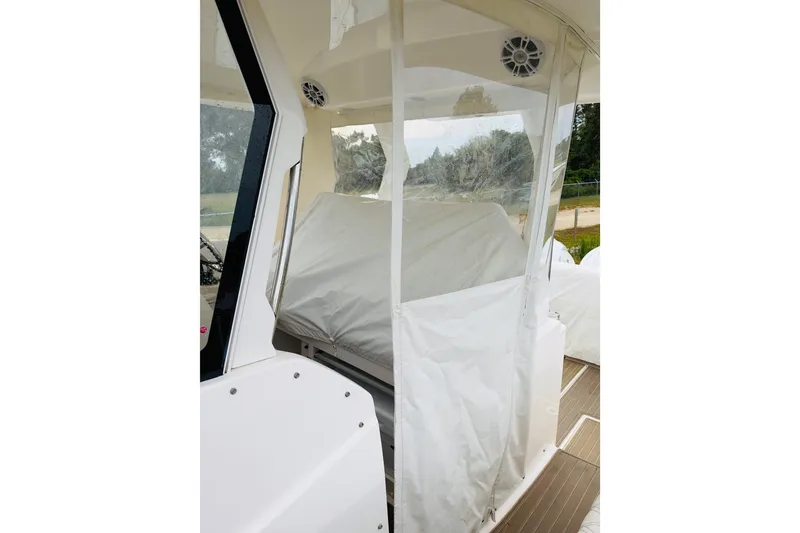 Slide: The Image of 2024 Regal 33 SAV boat interior with protective covers and clear panels. - 22