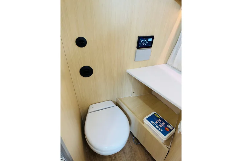 Slide: The Image of Modern bathroom in 2024 Regal 33 SAV boat with toilet and first aid kit. - 15