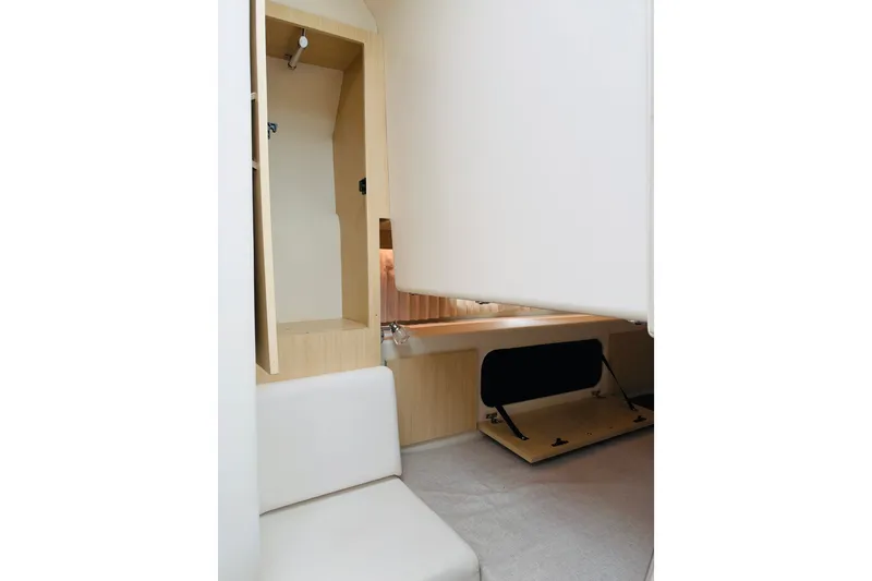 Slide: The Image of 2024 Regal 33 SAV interior cabin with seating and storage space. - 17