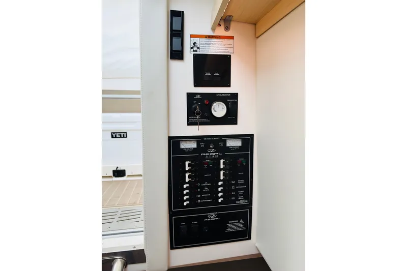 Slide: The Image of 2024 Regal 33 SAV control panel with switches and level monitor. - 18