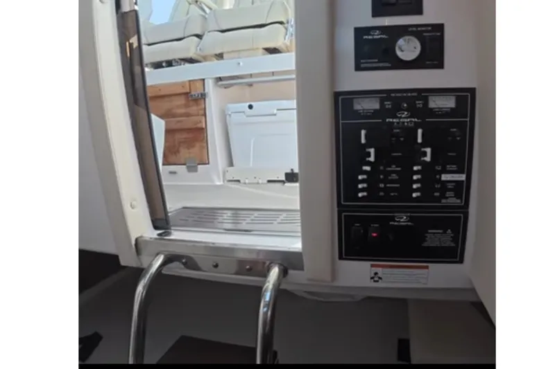 Slide: The Image of 2024 Regal 33 SAV boat interior with control panel and seating area. - 9