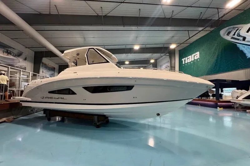 The Image of 2024 Regal 33 SAV boat displayed indoors, showcasing sleek design and modern features. - 0