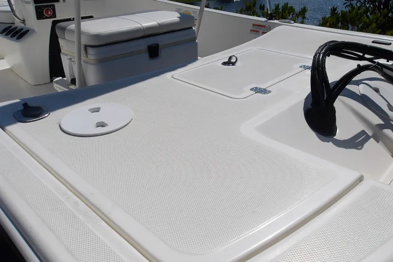Slide: The Image of 2024 Mako Pro Skiff 17 CC boat deck with storage compartments and seating. - 8