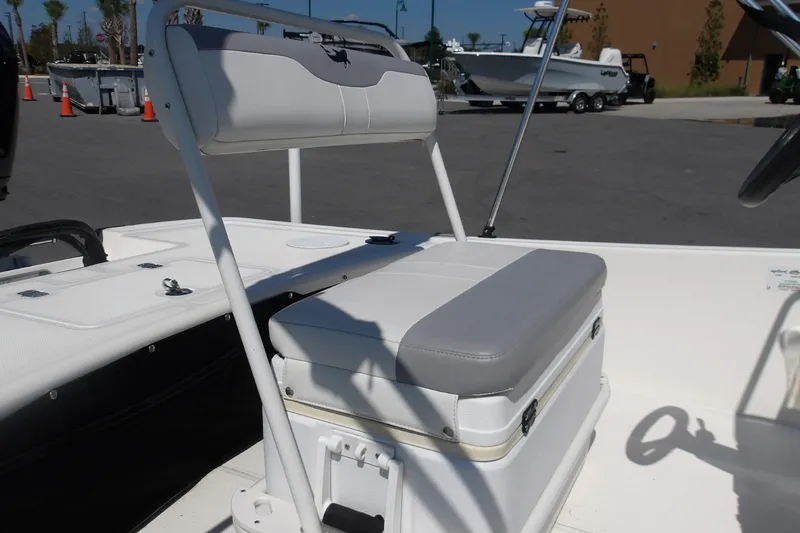 Slide: The Image of 2024 Mako Pro Skiff 17 CC boat interior with cushioned seating and storage. - 4