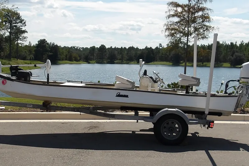 The Image of 2004 Gheenoe Classic 15 boat on trailer by a scenic lake. - 1