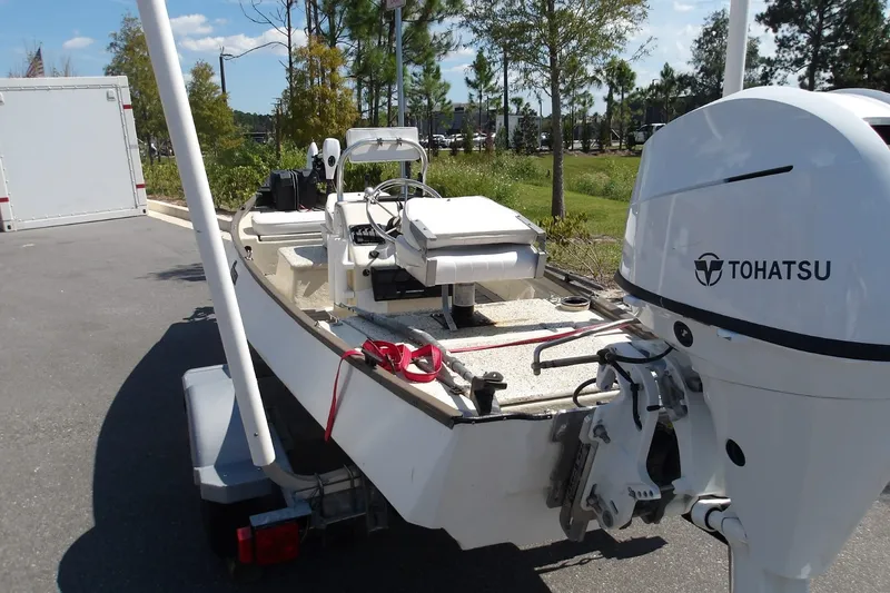 Slide: The Image of 2004 Gheenoe Classic 15 boat with Tohatsu motor on trailer, parked outdoors. - 4