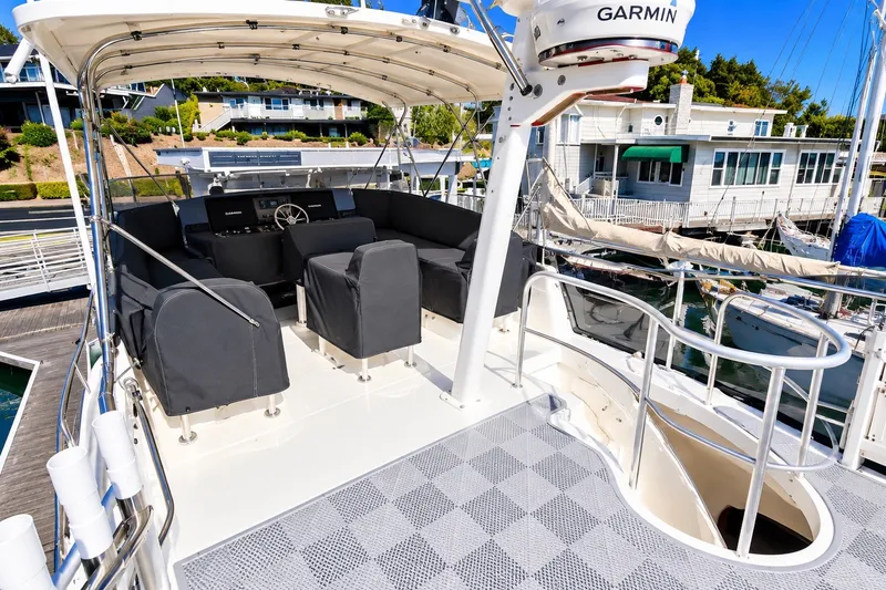 Slide: The Image of 2001 Mainship 390 Trawler flybridge with covered seating and Garmin navigation system. - 10