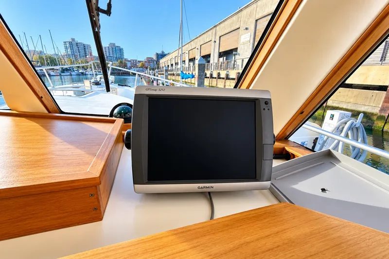 Slide: The Image of Garmin GPSmap 5212 on 2001 Mainship 390 Trawler, docked at marina with cityscape view. - 21
