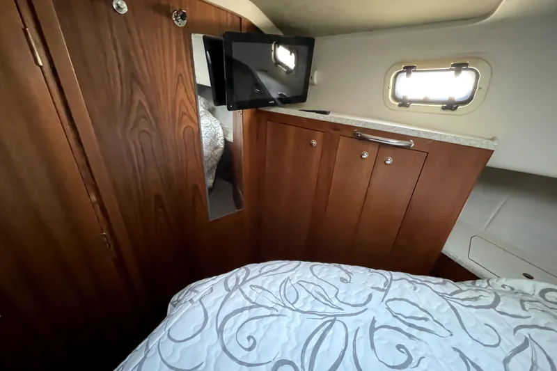 Slide: The Image of 2001 Mainship 390 Trawler cabin interior with wood cabinetry and small window. - 17