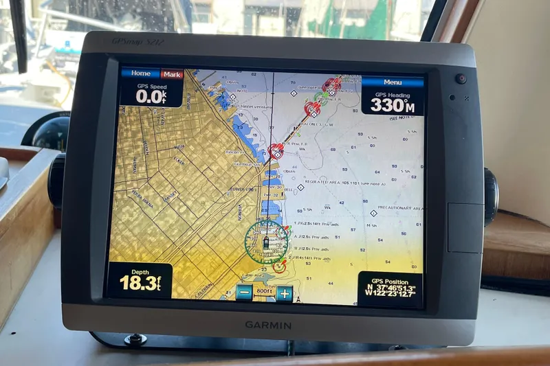 Slide: The Image of Garmin GPS display on 2001 Mainship 390 Trawler, showing navigation map and coordinates. - 15
