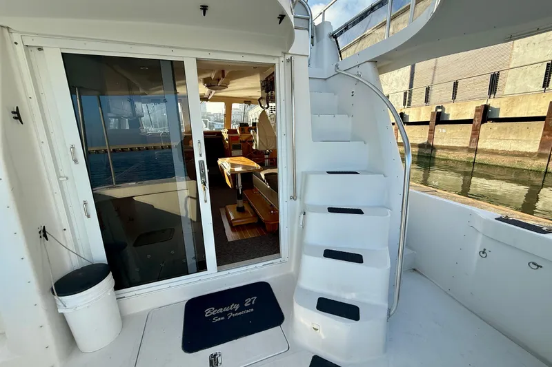 Slide: The Image of 2001 Mainship 390 Trawler interior view with stairs and sliding door. - 24