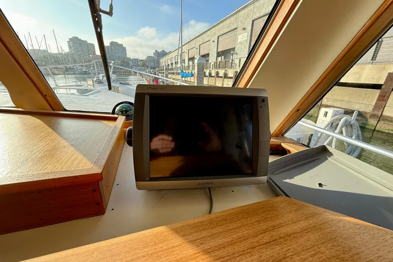 Slide: The Image of 2001 Mainship 390 Trawler helm with Garmin GPS, docked in marina. - 14