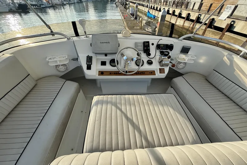 Slide: The Image of 2001 Mainship 390 Trawler helm with Garmin navigation, docked at marina. - 28