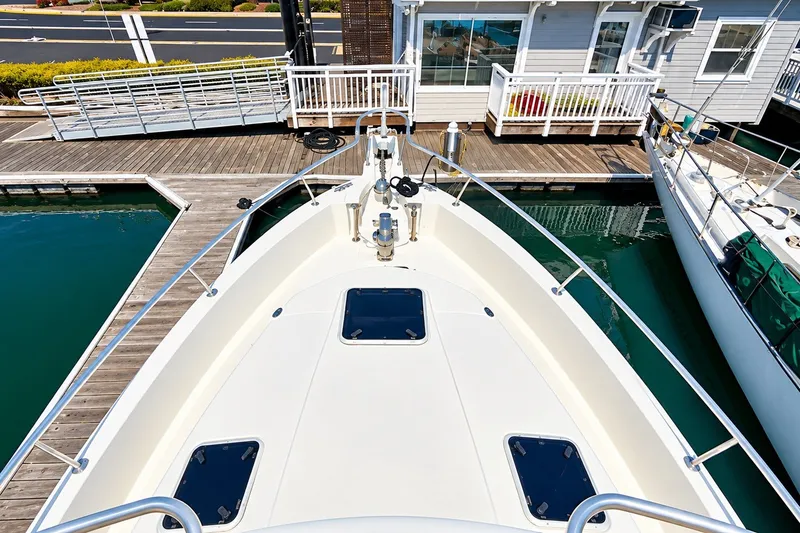 Slide: The Image of 2001 Mainship 390 Trawler docked at marina, viewed from bow. - 12